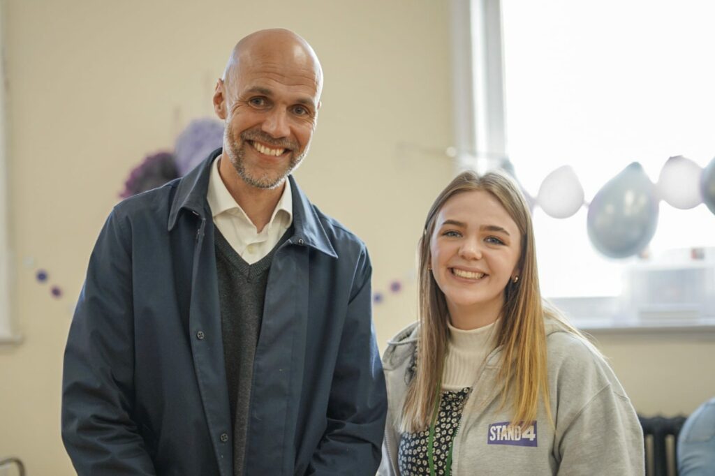 Chloe Sutton and Richard Haigh, CEO of The Key photographed at the STAND4 podcast launch event. Chloe wearing grey STAND4 hoodie.